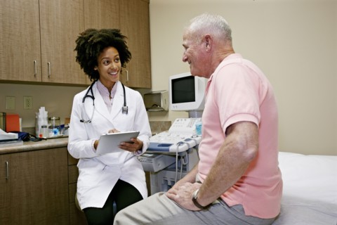 Doctor talking to patient in office