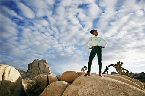 Black runner in desert landscape