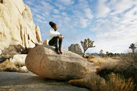 Black runner in desert landscape