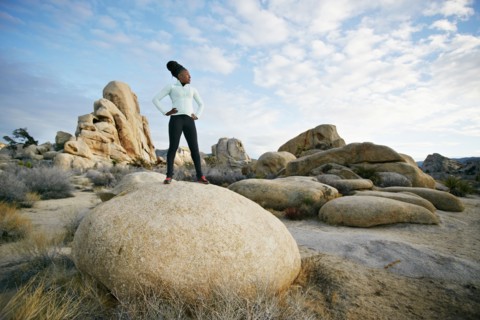 Black runner in desert landscape