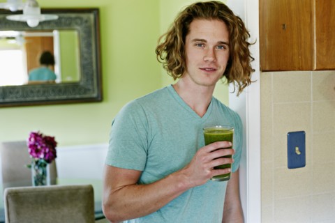 Caucasian man having glass of juice