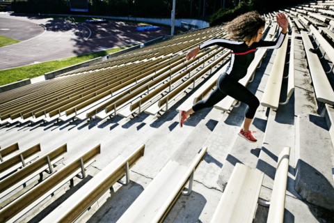 Mixed race runner training in stadium