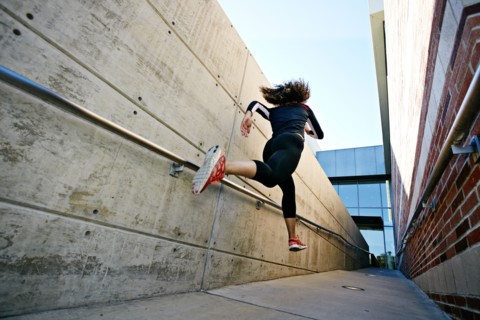 Mixed race runner training in stadium
