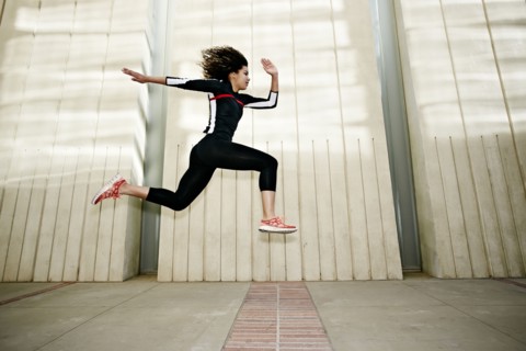 Mixed race woman running on city street