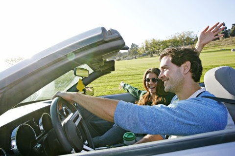 Couple driving in convertible