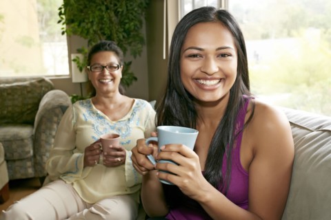 Mother and daughter having coffee together