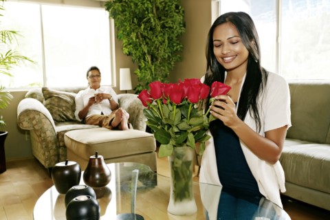 Woman arranging flowers in vase