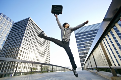 Asian businessman leaping on urban walkway