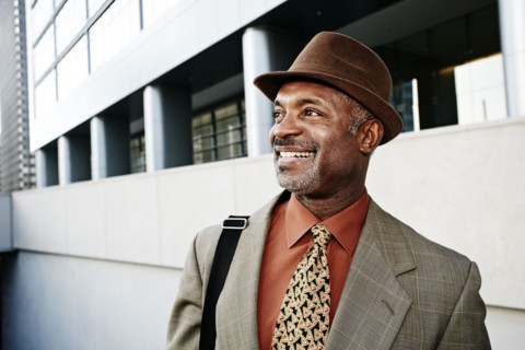 Black businessman standing on city street