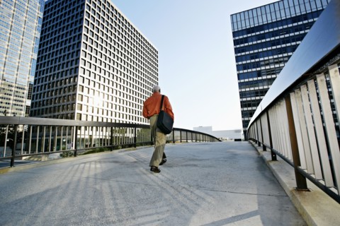 Black businessman walking on urban walkway
