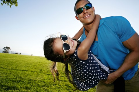 Father and daughter playing in field