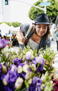Black woman looking at flowers