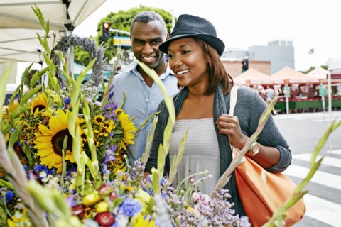 Black couple shopping at outdoor market