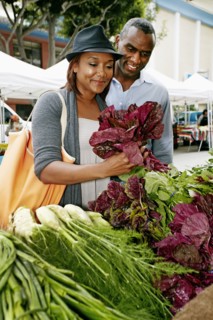 Black couple shopping at outdoor market