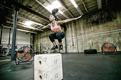 Mixed race woman exercising in gym