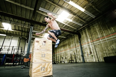 Mixed race man exercising in gym