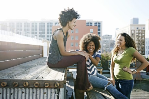 Women relaxing on urban rooftop