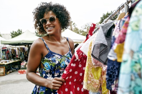 Mixed race woman shopping at flea market