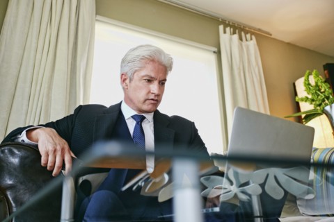 Caucasian businessman working in living room