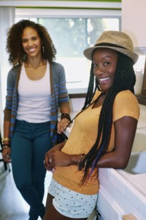 Women smiling together in kitchen