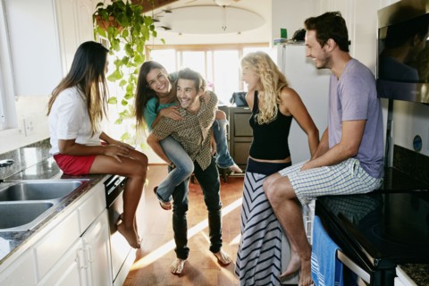 Friends relaxing together in kitchen
