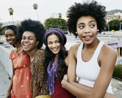 Women smiling on urban rooftop