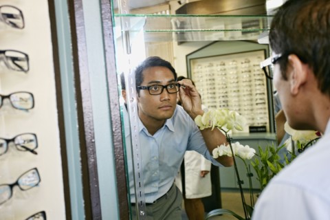 Filipino man trying on glasses at optometrist
