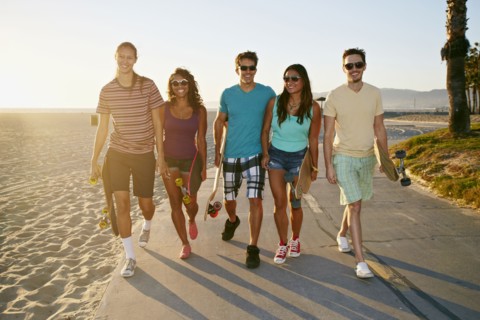Friends walking together on beach