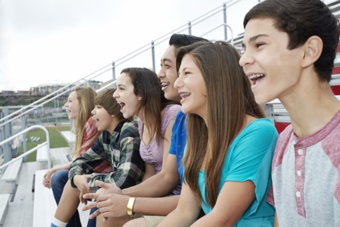 Teenagers watching game from bleachers