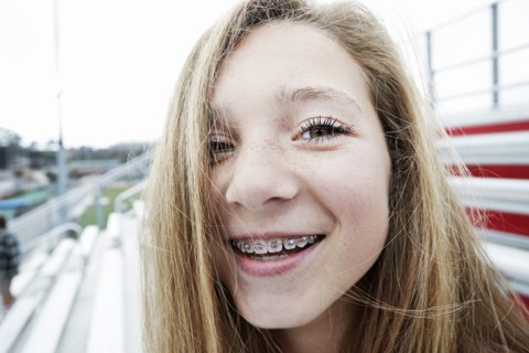 Teenage girl smiling on bleachers
