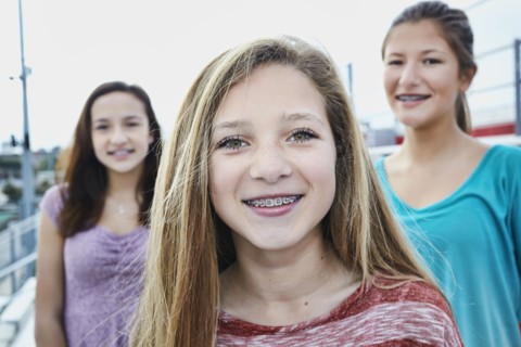 Teenage girls smiling on bleachers