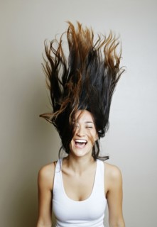 Mixed race woman tossing her hair