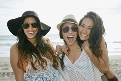 Women smiling together on beach
