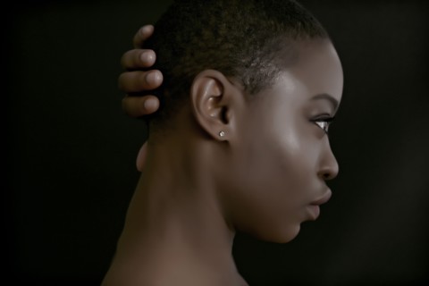 Black woman with hand behind head