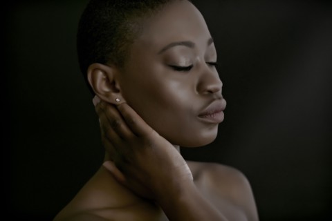 Black woman with hand on neck