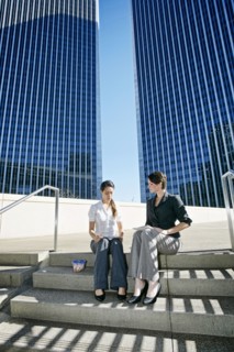 Businesswomen talking on city staircase