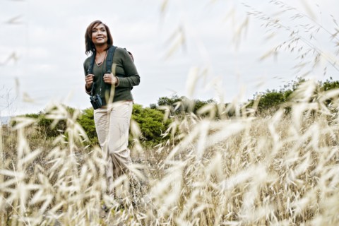 Black woman hiking on rural hillside