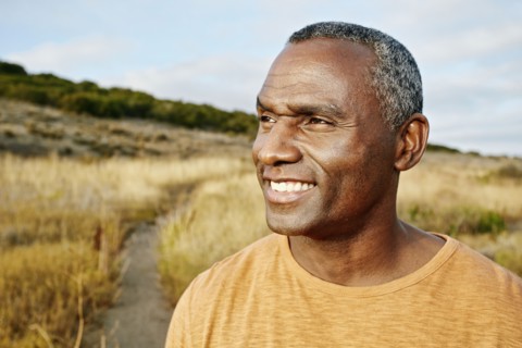 Black man standing on rural path