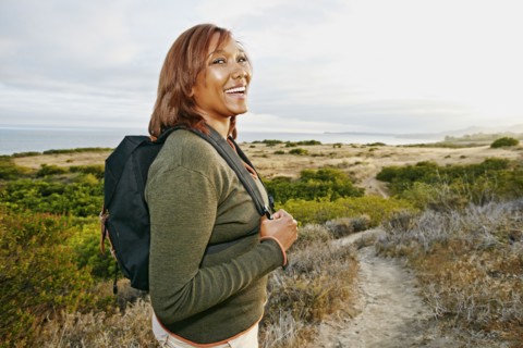 Black woman hiking on rural path