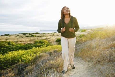 Black woman standing on rural hillside