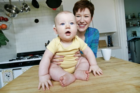 Caucasian mother and baby relaxing in kitchen