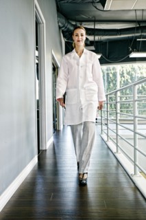 Caucasian doctor smiling in corridor