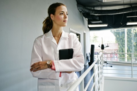 Caucasian doctor holding digital tablet near railing