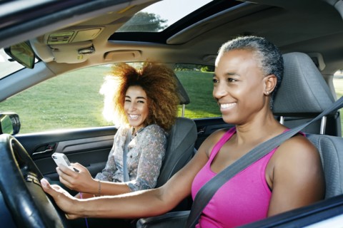 Mother and daughter driving car