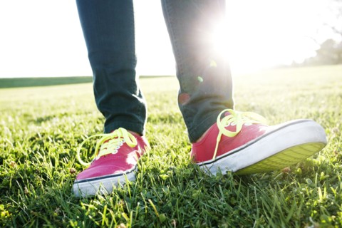 Close up of Hispanic woman's sneakers
