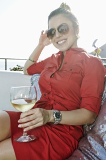 Mixed race woman drinking white wine