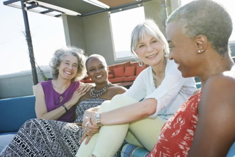 Women relaxing together on urban rooftop