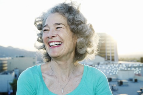 Caucasian woman smiling on urban rooftop
