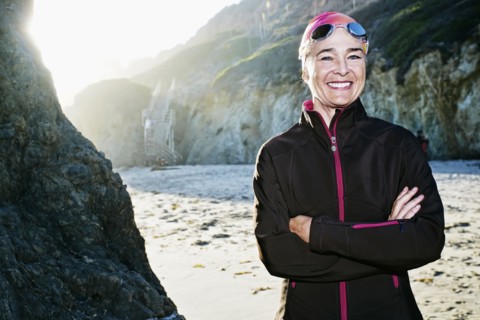 Older Caucasian woman wearing goggles on beach
