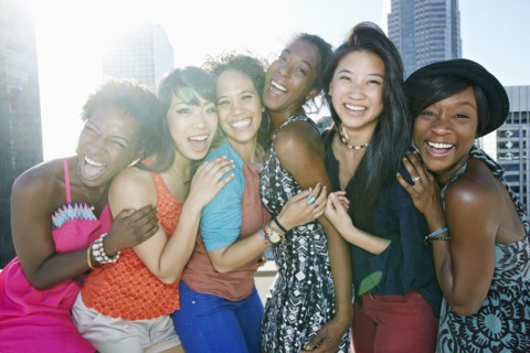 Women hugging on urban rooftop